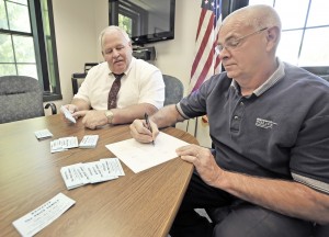 Southwick Police Chief David Ricardi, left, joins Lt. Kevin Bishop, in the preperation of a fundraising event for a Southwick family that was burned out of their home during a Mother's Day fire. The fundraiser will benefit the Price family and is sponsored by the Southwick Police Assocation. The May 30, Friday night event will be staged at the American Legion on Powder Mill Road and will feature a picnic-style supper, music and raffle prizes. (Photo by Frederick Gore)