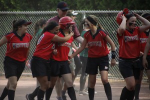 Westfield softball's Victoria Camp is swarmed by her teammates after hitting a walk off single to win the game for the Bombers to improve to 19-0 earlier this week. The Bombers capped off a perfect regular season Friday. (Photo courtesy of Mike Minicucci)