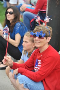 With celebratory glasses, patriotic deally-bobbers and a whirligig, Connie Hosmer of Southwick watches the Westfield Memorial Day parade yesterday with her granddaughter, Gwenn Hosmer, 8. (Photo © 2014 Carl E. Hartdegen)