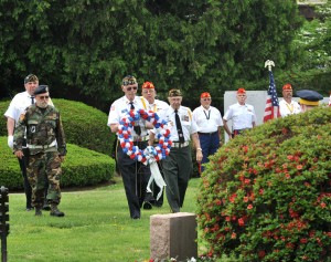The leaders of the city’s veteran’s organizations escort a wreath to a monument in Parker Park yesterday during ceremonies to conclude the annual Memorial Day observances in the city. (Photo © 2014 Carl E. Hartdegen)