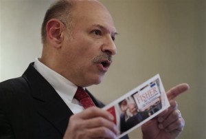 CRepublican candidate for governor of Massachusetts Mark Fisher displays a campaign brochure while facing reporters during a news conference at a hotel in Boston yesterday. Fisher addressed the Republican party's offer to allow him on the primary election ballot if he agrees to put off a lawsuit challenging the disputed results of the GOP state convention. (AP Photo/Steven Senne)