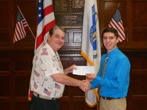 Bobby Callahan , left,  Director of Veterans’ Services for the City of Westfield, presents a check to Brian Mitchell on behalf of the Western Massachusetts Veterans’ Services Officers Association (WMVSOA).  Brian is a recent graduate of Westfield High School and is a 2014 recipient of the annual WMVSOA scholarship.  Brian will be attending Worcester Polytechnic Institute in the fall and will be majoring in Computer and Electrical Engineering.  (Photo submitted)