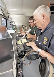 Charles Dunlap, Southwick emergency management director, foreground, uses the emergency communications vehicle to communicate with amateur radio operators around the country in a simulated disaster drill. (File photo by Frederick Gore)