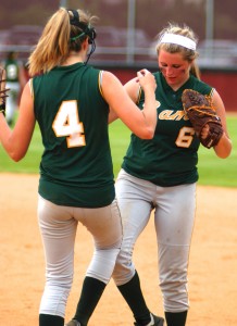 Southwick-Tolland Regional High School's Morgan Harriman, left, and Jennifer Yellin (6) perform a ritual in between innings Tuesday. (Photo by Chris Putz