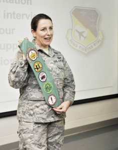 Maj. Mary Harrington, of the 104th Fighter Wing at Barnes Regional Airport, displays some of her Girl Scout badges she earned as scouts from across the area toured the military base Saturday. The scouts were introduced to female military personnel who spoke of the important life lessons that were taught to them during their younger years. (Photo by Frederick Gore)