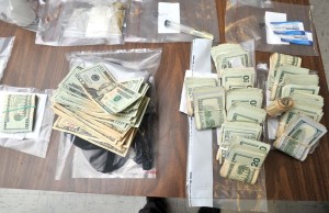 Detectives seized $17,220 and about two pounds of marijuana when they executed a warrant Wednesday evening on Gold Street. (Photo by Carl E. Hartdegen)