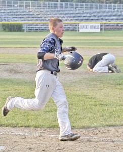 Westfield's Nate Bonini foreground, claims the winning run as Trumbull pitcher Tyler Zikias, background, falls to the ground after giving up the winning hit. (Photo by Frederick Gore)