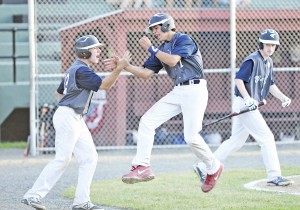 Westfield's Tyler Delgado, center, leaps for joy as Jack Yvon, left, slaps a high five after Delgado scored in the first inning during the 14-Year-Old 2014 Babe Ruth New England Regional Tournament against visiting Windham, Maine at Bullens Field, Saturday evening. (Photo by Frederick Gore)