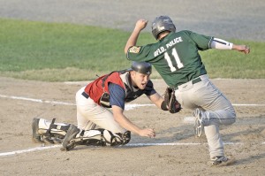 Westfield Post 124 catcher Cameron Robitaille, left, tags out Greenfield Post 81 baserunner Brody Markol during Tuesday night's Game 1 of the American Legion Baseball state sectionals championship (best-of-3 series) at Bullens Field. (Photo by Frederick Gore)