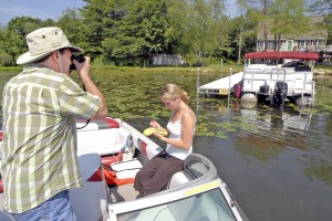 Volunteers and officials from the Town of Southwick use a GPS receiver device and camera to document docks and floating platforms around the Congamond Lakes. (File photo by Frederick Gore)