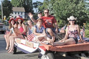 Family and friends from the Wyben area wave to the crowd from their homemade float as part of the annual Wyben Independence Day Parade. The Wyben parade begins at 6 p.m. and all are welcome.  (File photo by Frederick Gore)