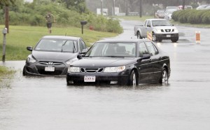 Motorists and business owners along Mainline Drive in Westfield became stranded as heavy rains hit the area yesterday.  A state police trooper on the scene said the water was initially up to the front grills of both vehicles which become stranded in the roadway. (Photo by Frederick Gore)