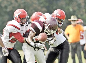 The Bombers swarm the Amherst ball carrier. (Photo by Frederick Gore) 