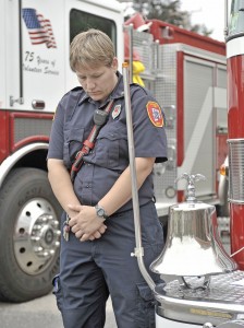 Jessica Bishop, a member of the Southwick Fire Department, prepares to ring a bell during a 9/11 Remembrance Ceremony in Southwick yesterday. (Photo by Frederick Gore)