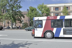 A bus owned by the Pioneer Valley Transit Authority (PVTA) passes the United Bank and the Westfield Athenaeum on Elm Street where a proposed PVTA bus stop could be located. (Photo by Frederick Gore)