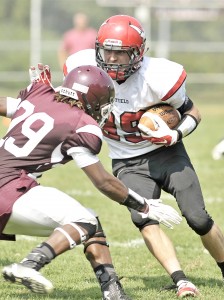 Amherst defensive back Jericho Sylla attempts to stop Westfield senior halfback Cody Neidig, who carries the ball into the teeth of the Hurricanes defense in Saturday's season opener. (Photo by Frederick Gore)