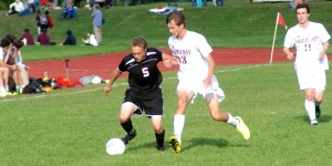 Westfield's Matt Chlastawa (5) holds off Amherst while dribbling the ball out along the sidelines. (Photo by Chris Putz)