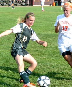 Southwick's Rachel Healey (23) gets a foot on the ball just prior to Agawam's arrival. (Photo by Chris Putz)