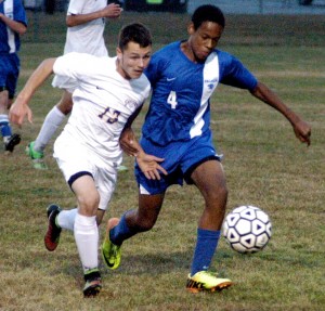 Gateway's Walker Lee, left, and Palmer's Austin Coffee-Lee (4) battle for possession of the ball Monday night. (Photo by Chris Putz)