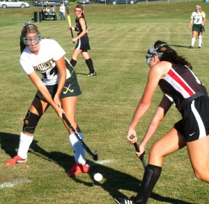 Southwick's Morgan Harriman attempts to flick the ball past an oncoming Westfield defender. (Photo by Chris Putz)