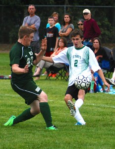 St. Mary's Joey Collins, right, gets a foot on the ball before McCann Tech can react to the play. (Photo by Chris Putz)