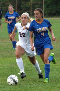 Bombers' Annie Brozini attempts to outrace a Comp's Jillian Devlin, right, to the ball Thursday. (Photo by Chris Putz)
