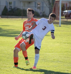 Westfield High junior captain Matthew Butera knocks the ball free from an Agawam defender Monday. (Photo by Liam Sheehan)