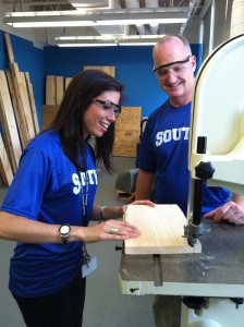 South Middle School Assistant Principal Jessica Kennedy (left) tries out a saw with Shop Instructor Dan Sheehan in the school's first woodshop in 10 years. (Photo by Peter Francis)