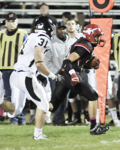 Westfield's Nick Nihill, right, carries as Longmeadow's Conrad McCatrthy attempts the tackle during the second quarter of Friday night's game at Bullens Field. (Photo by Frederick Gore)
