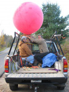University of Massachusetts, Amherst, Environmental Conservation graduate student Anthony Volpini, left and Professor Charles Schweik of the Center for Public Policy and Administration prepare to launch a helium balloon to photograph the brickyard ponds west of Root Road yesterday morning. (Photo by Dan Moriarty)