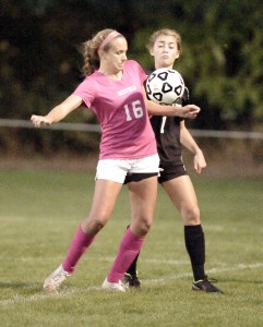 Westfield senior Karly Diltz, left, battles Longmeadow sophomore Courtney Barrett during Thursday night's high school girls' soccer game Bullens Field. (Photo by Frederick Gore)