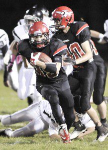 Westfield's Cody Neidig, foreground, carries in the first quarter for the first touchdown for Westfield during last night's game against visiting Longmeadow. (Photo by Frederick Gore)