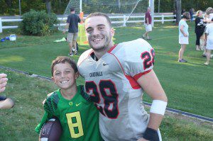 Catholic University of American football player Billy Smith, right, of Westfield, stands alongside his cousin, Jamie following a game in 2014. (File photo)