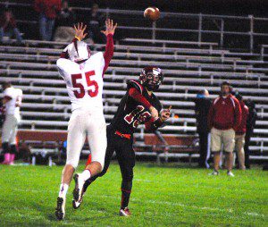 Westfield sophomore quarterback Austin St. Pierre (19) fires a pass as East Longmeadow defensive lineman Connor Humphries tries to get a hand in his face Friday night at Bullens Field. (Photo by Chris Putz)