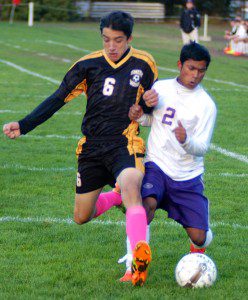 Voc-Tech's Laxmi Basnet, right, battles a Smith Voke player for position and possession of the ball Thursday. (Photo by Chris Putz)