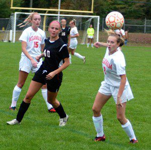 The Westfield and Agawam high school girls' soccer teams follow the flight of the ball Monday. (Photo by Chris Putz)