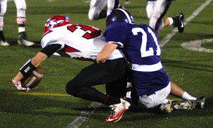 Westfield senior running back Cody Neidig attempts to stretch for additional yardage as Holyoke senior defensive back Francis Hoey drags him down from behind Friday night at Roberts Field. (Photo by Chris Putz)
