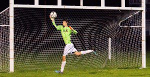 Westfield senior goalie Ryan Fitzgibons makes a leaping save against Chicopee on Monday night. (Photo by Liam Sheehan)