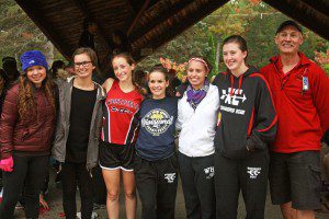 Westfield High girls' cross country seniors Libby Hickson Azocar, Celina Billerbeck, Hannah Giffune, Amanda Haluch and Sam Tuttle and Kaliegh Florek, stand alongside coach Mike Rowbotham on senior day. (Photo by Kate McCabe)