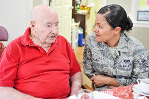 Glenda Schuster, right, of the Barnes 104th Fighter Wing in Westfield, chats with Dominic DelBuono, a World War II Army medical veteran, during a special Veterans Day luncheon at the Heritage Woods Assisted Living Center in Agawam yesterday. More than a dozen military personnel from the 104th Fighter Wing joined 17 retired veterans presently living at the center.  (Photo by Frederick Gore)