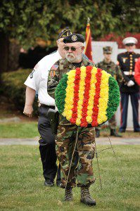 Westfield veterans organizations and city officials gathered at the conclusion of a parade hosted by the American Legion Post 454 at Parker Memorial Park. Here, a vetran places a wreath as part of a memorial ceremony. (Photo by Frederick Gore)