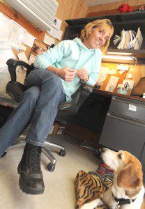 Lori Charette, the city's manager of animal control operations, is seen in her office with 'Spud', an unclaimed tri-color beagle dog recovering from minor surgery. Charrette was recently named ACO of the Year by professionals in her field. (Photo by Carl E. Hartdegen)