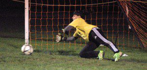 Southwick goalie Tori Richburg makes a sensational save during the shootout portion of Monday's playoff game at South Hadley. (Photo by Chris Putz)