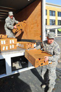TSgt. Ken McElroy and Michael Stula, of the 104th Fighter Wing at Barnes, helps unload a truck load of fresh frozen turkeys to the Westfield Salvation Army Service Center on Arnold Street in preparation of Thanksgiving Day. File photo by Frederick Gore)