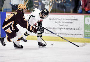 St. Mary's Andrew Booth, right, battles Chicopee's Ben Jablonski recently at the Amelia Park Ice Arena. (Photo by Frederick Gore)