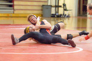 Bombers' Jordan Cree holds down his Dean Tech opponent and looks at the official for a call on the pin. (Photo by Liam Sheehan)