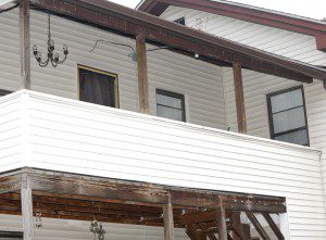 Black plastic sheeting covers a second floor window which was smashed out when  an intruder broke into  a Chapel Street house Saturday morning. (Photo by Carl E. Hartdegen)