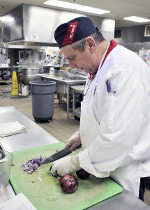 John Elburn, an employee for the Sodexo Corporation which serves the dining commons at Westfield State University, prepares vegetables at a special allergen and gluten free food service area of the kitchen. Employees of the organization have been specially trained for allergen and gluten free awareness as recognized by the Massachusetts Restaurant Association. (Photo by Frederick Gore)