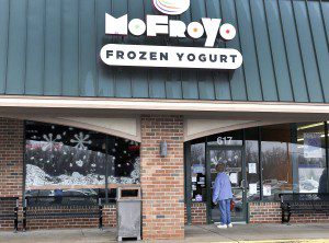 A woman looks into the window of the MoFroYo Lounge at 617 East Main Street in Westfield. After only two years of doing business, the frozen yogurt shop, established by Westfield businessman Todd Cieplinski, will be closing. (Photo by Frederick Gore)