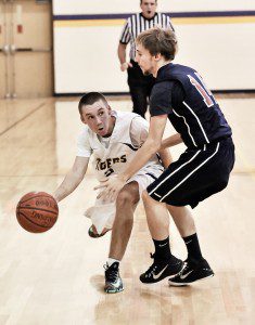 Westfield Voc-Tech's Matt Wood, left, dribbles past Hampden Charter School of Science defender Zack Paul during the second quarter of Monday night's game in Westfield. (Photo by Frederick Gore)